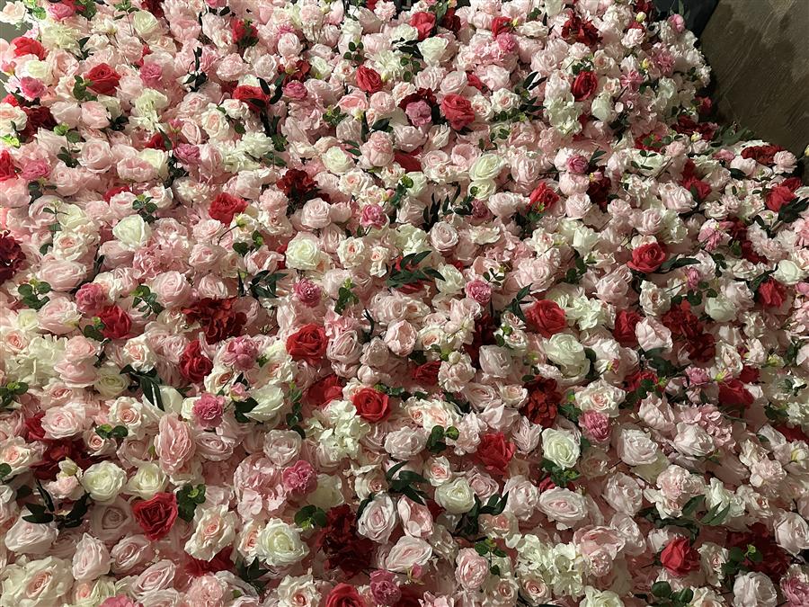 Detail view of a blush, ivory, and red rose wallflower backdrop